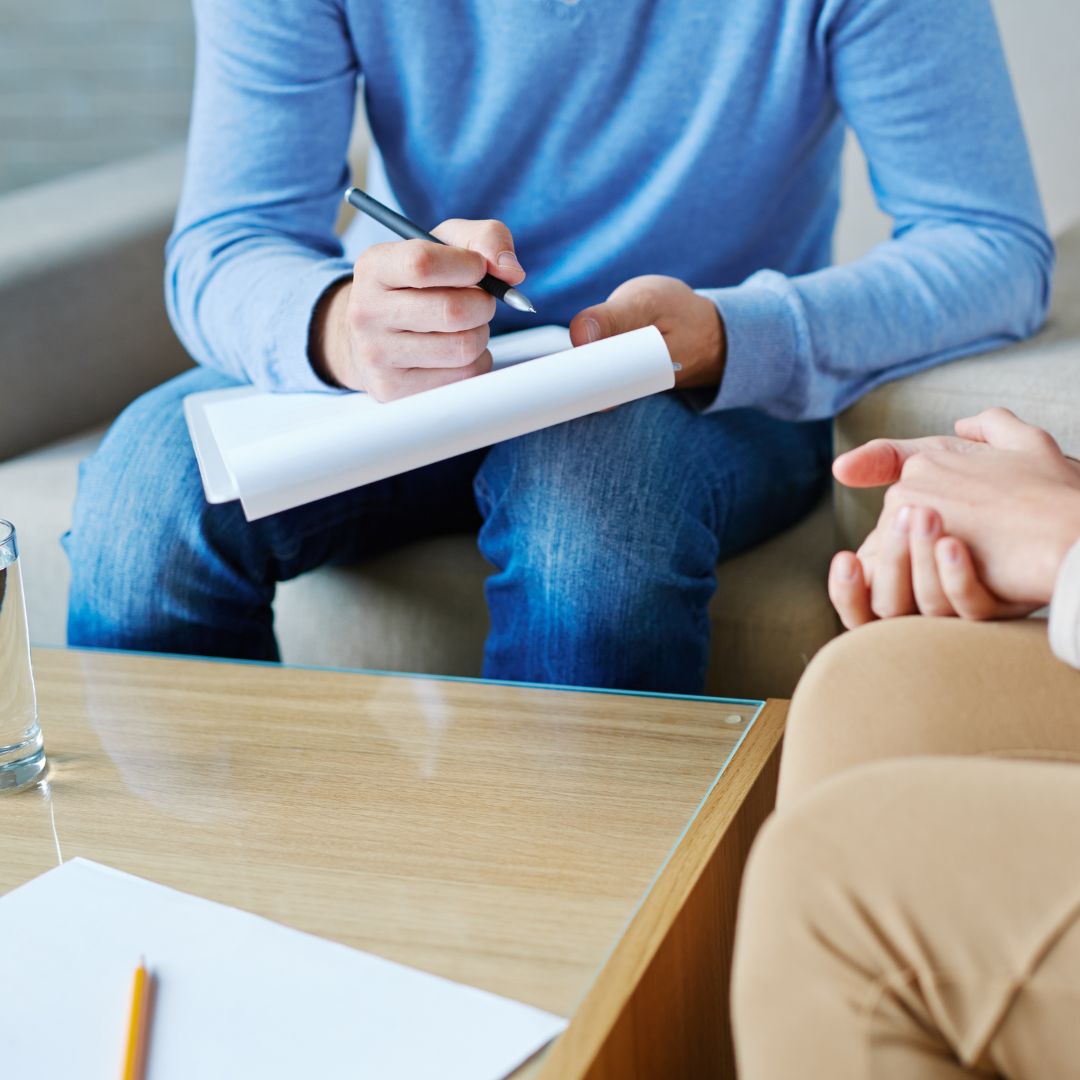 Therapist noting patient speech during personal session